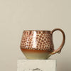 Ceramic mug with leopard print pattern on a beige background