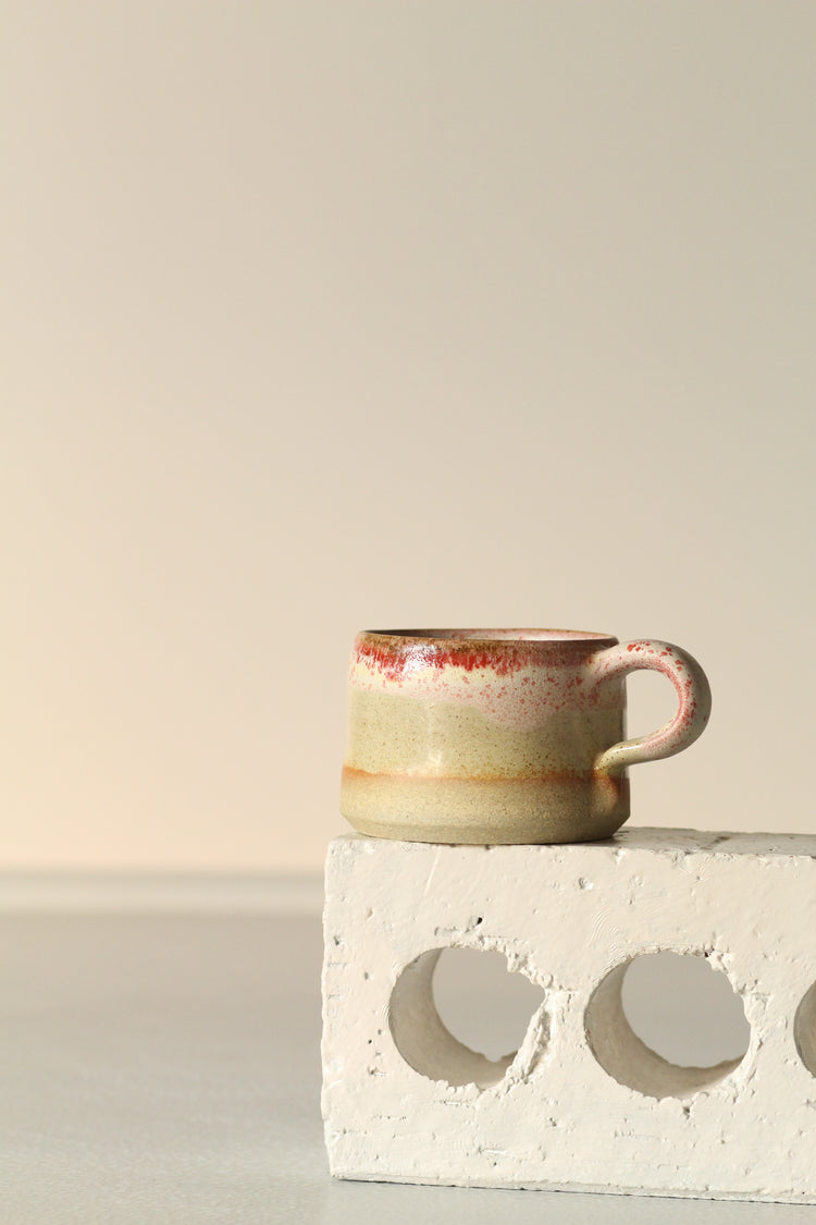 Cream mug with a salted red rim