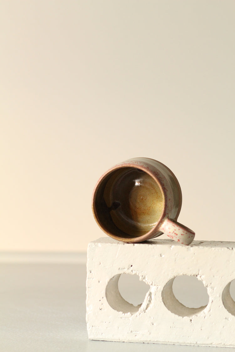 Cream mug with a salted red rim