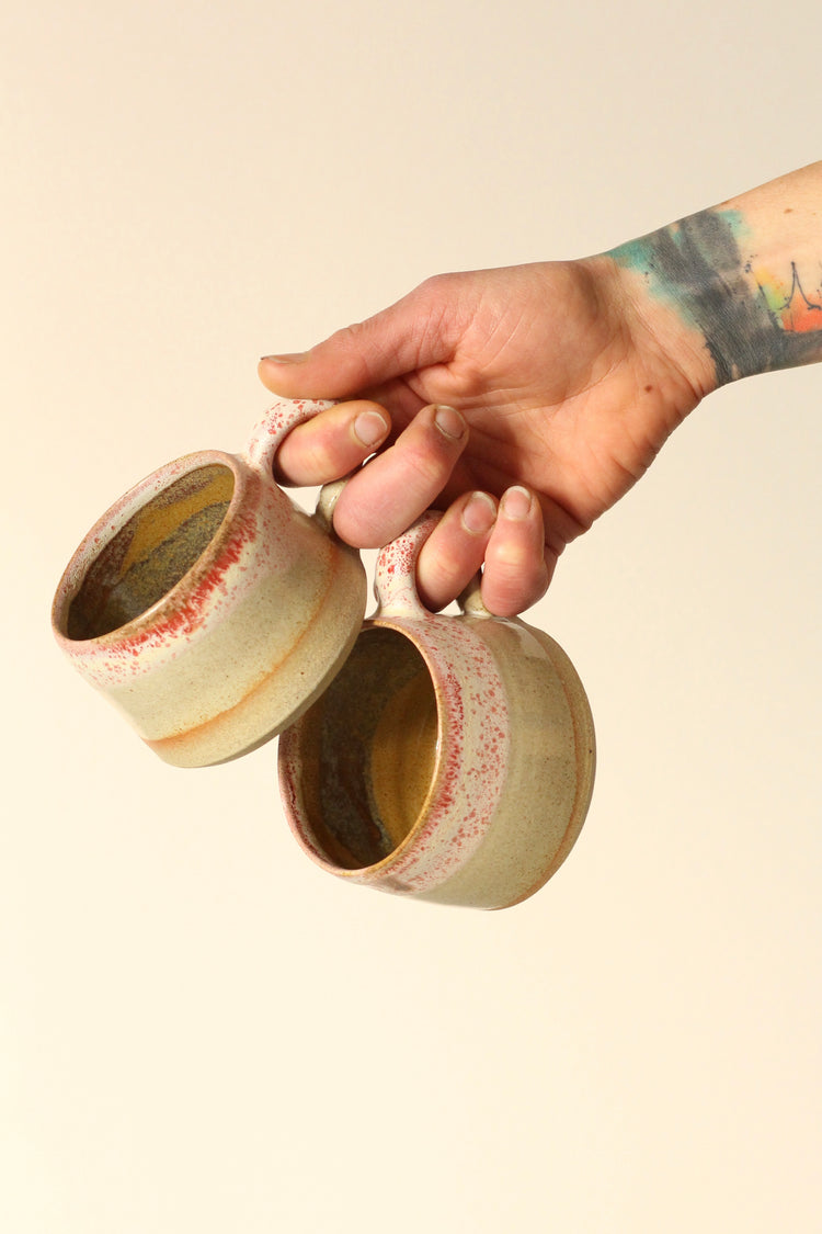 Cream mug with a salted red rim