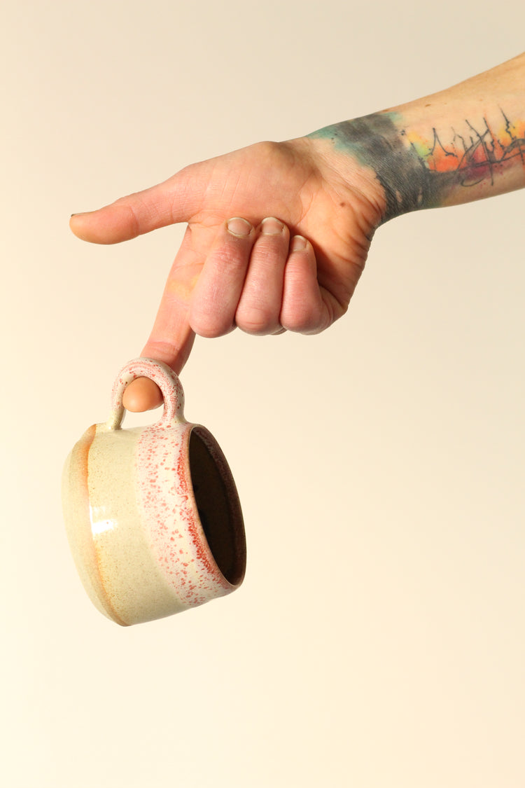 Cream mug with a salted red rim