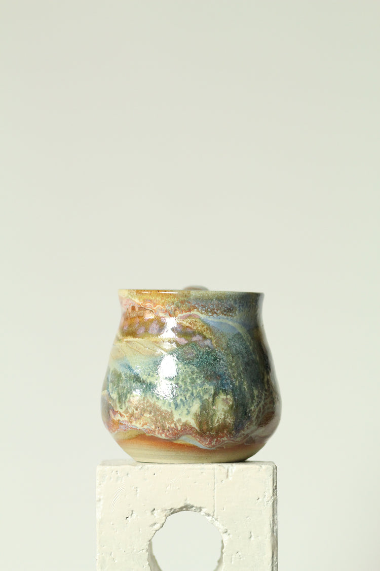 Decorative mug with a white rectangular object on a light gray background