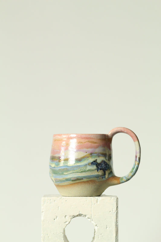 Colourful ceramic mug on a plain background with polka dot kangaroo