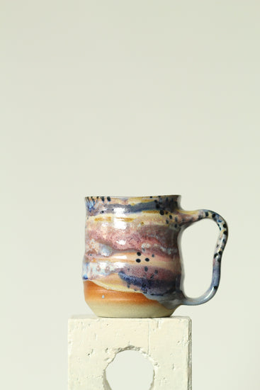 Handmade ceramic mug in the Body form with Imprint handle detail, finished in painterly Dusk glaze with layered blues, violet and warm clay tones.
