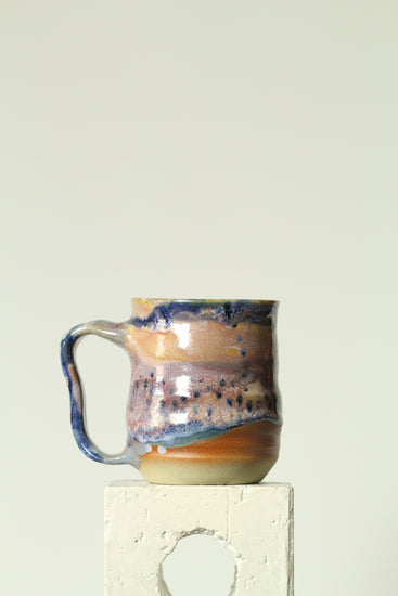 Handmade ceramic mug in the Body form with Imprint handle detail, finished in painterly Dusk glaze with layered blues, violet and warm clay tones.