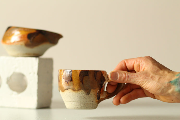 Twisted handle cup and bowl with spout